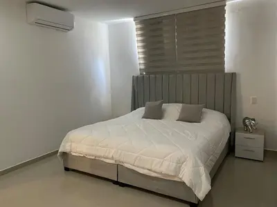 a bedroom with a large bed with white sheets at Luxury Apartment in Great Area! in Barranquilla