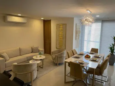 a living room with a couch and a table and chairs at Luxury Apartment in Great Area! in Barranquilla