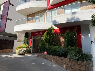 a apartment building with a red and white facade at Luxury Apartment in Great Area! in Barranquilla