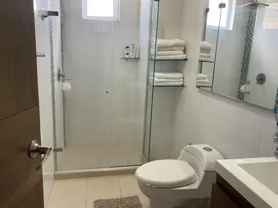 a bathroom with a shower and a toilet and a sink at Luxury Apartment in Great Area! in Barranquilla