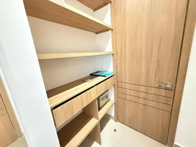 a closet with wooden shelves and a door at Suite Exclusiva Baia Kristal, Zona Kabo 3 in Cartagena de Indias