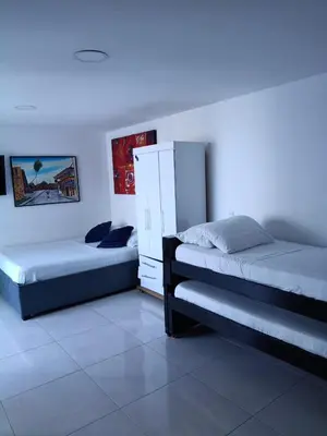 a bedroom with two beds and a white cabinet at Estudio piso 9 APTO 909 in Cartagena de Indias