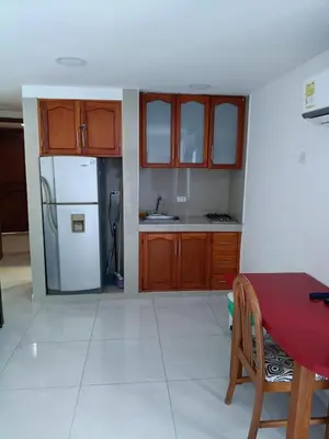 a kitchen with a red table and a white refrigerator at Estudio piso 9 APTO 909 in Cartagena de Indias
