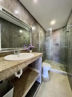 a bathroom with a sink and a toilet and a shower at Riviera Mulata Loft - Apartamento con vista al mar in Cartagena de Indias