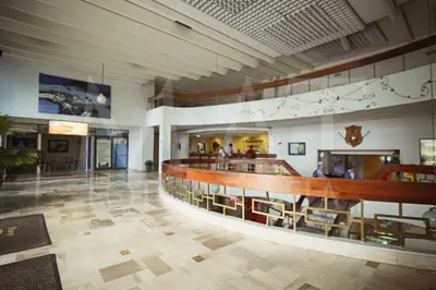 a large building with a lobby with tables and chairs at Riviera Mulata Loft - Apartamento con vista al mar in Cartagena de Indias