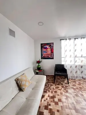 a living room with a white couch and a chair at Amoblados Cartagena, El Laguito in Cartagena de Indias