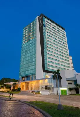 a large building with a sign on the side of it at Estelar Alto Prado Studio Apartmento in Barranquilla