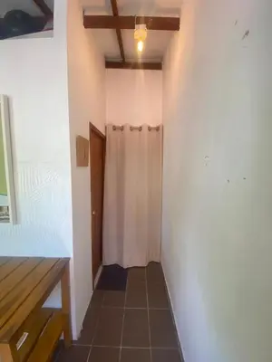 a hallway with a white wall and a ceiling at Apartaestudio con balcón cerca al mar in Puerto Colombia