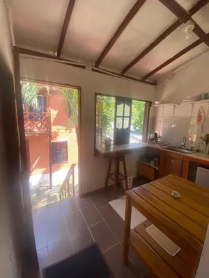 a kitchen with a wooden table and a wooden table sidx sidx sidx at Apartaestudio con balcón cerca al mar in Puerto Colombia
