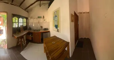 a kitchen with a wooden bench in a room at Apartaestudio con balcón cerca al mar in Puerto Colombia
