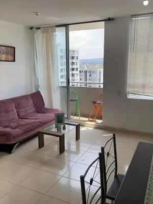 a living room with a purple couch and a table at Modern and renowned apartment in Cartagena in Cartagena de Indias