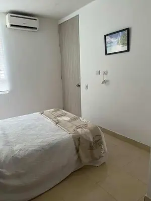 a bedroom with a bed in a white room at Modern and renowned apartment in Cartagena in Cartagena de Indias