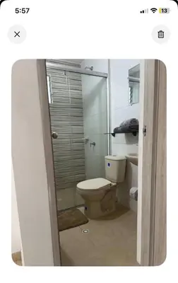 a bathroom with a toilet and a glass shower at Modern and renowned apartment in Cartagena in Cartagena de Indias