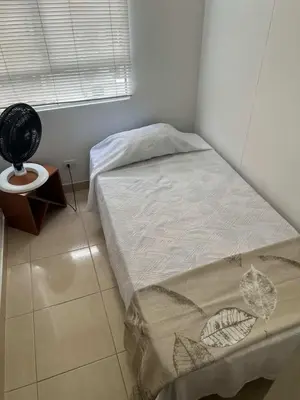 a small bedroom with a bed and a window at Modern and renowned apartment in Cartagena in Cartagena de Indias