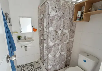 a bathroom with a shower with a toilet and a sink at Habitacion privada y central in Barranquilla
