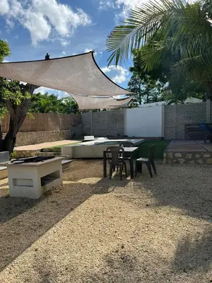 a patio with a table and chairs and a grill at House Las Palmas villa privada in Puerto Colombia
