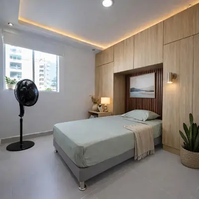 a bedroom with a bed and a fan in it at Despierta con vista al mar en el corazón de CTG in Cartagena de Indias
