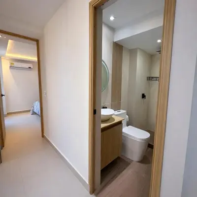 a bathroom with a toilet and a sink and a mirror at Despierta con vista al mar en el corazón de CTG in Cartagena de Indias