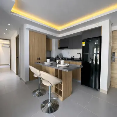 a kitchen with a counter and a black refrigerator at Despierta con vista al mar en el corazón de CTG in Cartagena de Indias