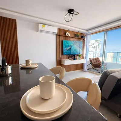 a kitchen and living room with a table and chairs at Despierta con vista al mar en el corazón de CTG in Cartagena de Indias