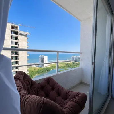 a couch sitting on a balcony with a view of the ocean at Despierta con vista al mar en el corazón de CTG in Cartagena de Indias