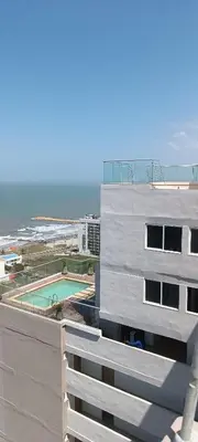a view of a building with a pool and the ocean at Cartagena Relax in Cartagena de Indias