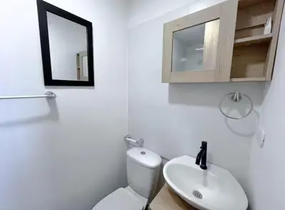 a bathroom with a toilet and a sink and a mirror at Cartagena Relax in Cartagena de Indias