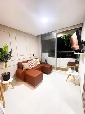 a living room with a couch and a large window at Business Stay More30Days Fast WiFi Premium Comfort in Cartagena de Indias