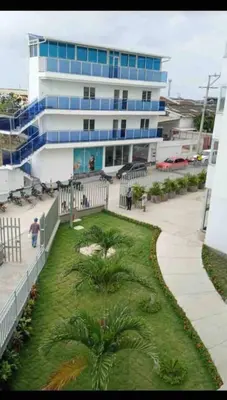a large building with palm trees in front of it at Business Stay More30Days Fast WiFi Premium Comfort in Cartagena de Indias