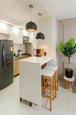 a kitchen with a white counter and a refrigerator at Business Stay More30Days Fast WiFi Premium Comfort in Cartagena de Indias