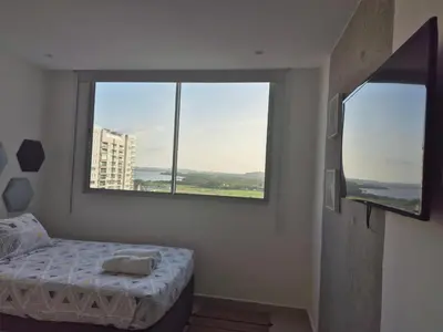 a bedroom with a bed and a large window at 2H Encanto rentals at Sunno Beach in Cartagena de Indias