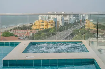 a swimming pool with a view of a city at 2H Encanto rentals at Sunno Beach in Cartagena de Indias