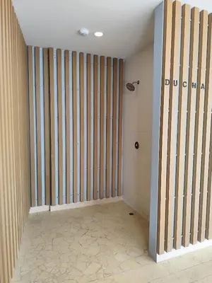 an empty room with a wall with vertical stripes at 2H Encanto rentals at Sunno Beach in Cartagena de Indias