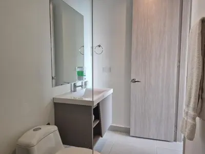 a bathroom with a toilet and a sink and a mirror at 2H Encanto rentals at Sunno Beach in Cartagena de Indias