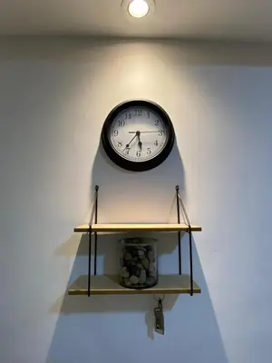 a clock hanging on a wall next to a shelf at Premium stay in a central area with parking in Cartagena de Indias