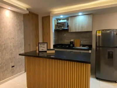 a kitchen with a counter and a refrigerator at Premium stay in a central area with parking in Cartagena de Indias