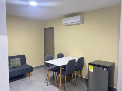 a room with a table and chairs and a heater at Nora la bella in Barranquilla