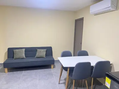 a living room with a couch and a table and chairs at Nora la bella in Barranquilla