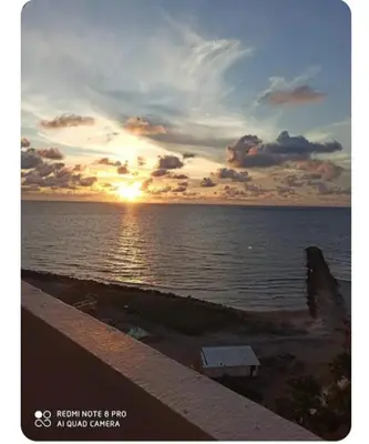 a sunset over a body of water with the sun setting at APARTAESTUDIO Con Espectacular Vista in Cartagena de Indias