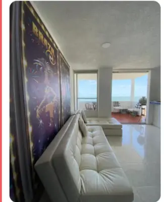 a living room with a white couch and a wall at APARTAESTUDIO Con Espectacular Vista in Cartagena de Indias