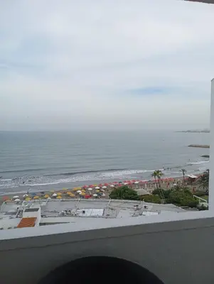a view of a beach with umbrellas and the ocean at APARTAESTUDIO Con Espectacular Vista in Cartagena de Indias