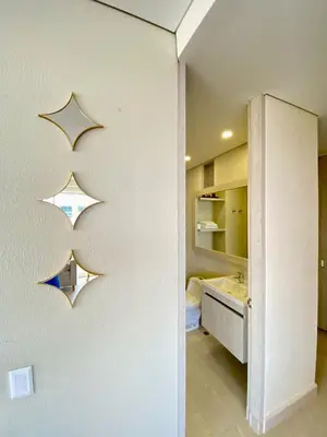 a room with a white wall with a mirror at Luxury Ocean View Aparment in Cartagena de Indias