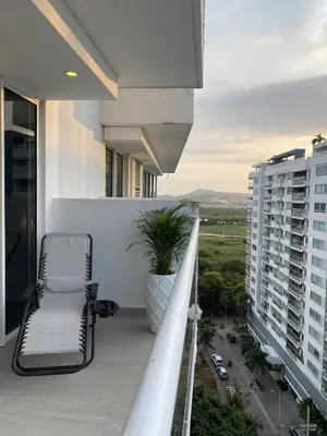a balcony with a chair and a view of a city at Luxury Ocean View Aparment in Cartagena de Indias