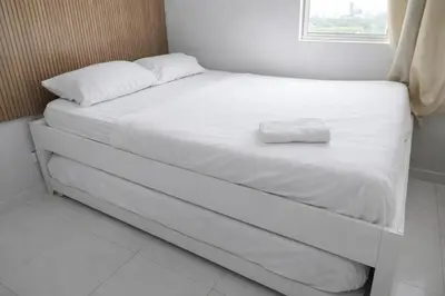 a white bed with a white pillow on it at walled city of Cartagena 20 in Cartagena de Indias