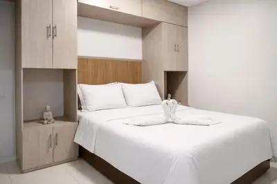 a bedroom with a large white bed and cabinets at walled city of Cartagena 20 in Cartagena de Indias
