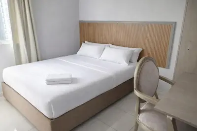 a bed in a room with a table and a chair at walled city of Cartagena 20 in Cartagena de Indias