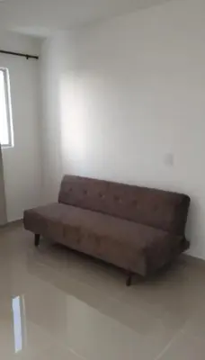 a brown couch sitting in a white room at Apartamento en Torices in Cartagena de Indias