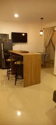 a living room with a table and a tv on the wall at Apartamento en Torices Piso 24 - Cartagena - Playa cerca al Mar in Cartagena de Indias