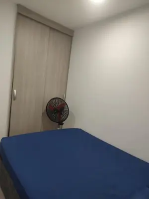 a room with a blue bed and a fan at Sagitario hospedaje in Cartagena de Indias