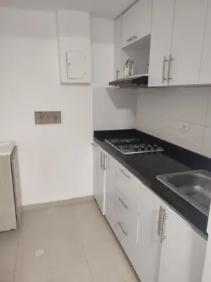 a white kitchen with a sink and a stove at Sagitario hospedaje in Cartagena de Indias